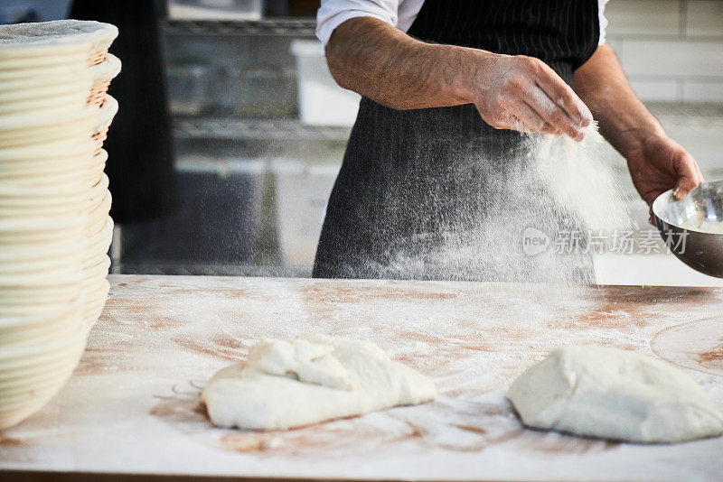 Chef  Dusting And Preparing Kitchen Counter With Flour To Make An Artisan Bread